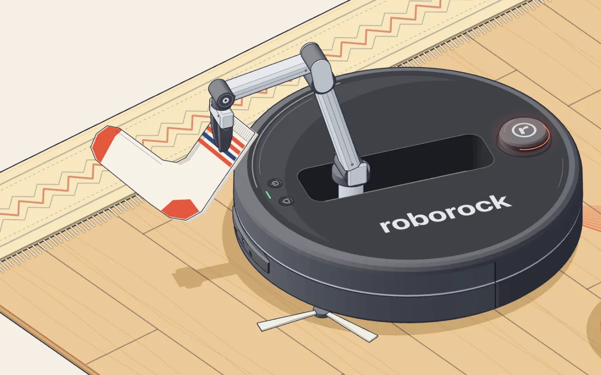 Un robot aspiradora con su brazo desplegado levantando un calcetín del piso.